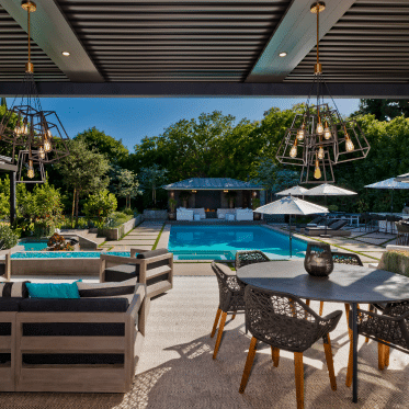 black louvers roof pergola next to pool