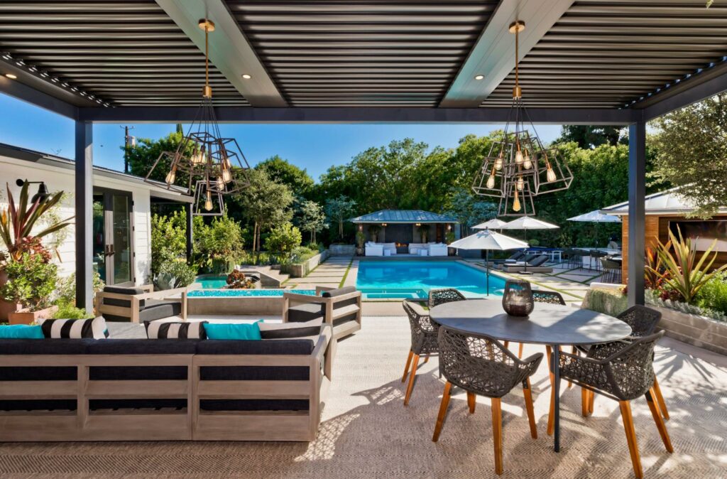 Photo of a motorized StruXure pergola with louvered roof providing shelter over an outdoor living room area
