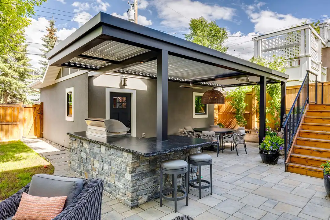 Photo of a StruXure pergola with outdoor kitchen, outdoor bar, and outdoor dining room.