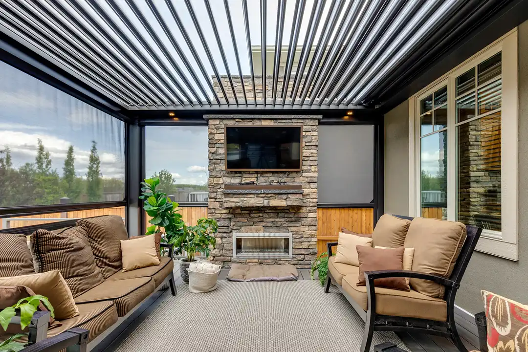 Photo of a StruXure louvered pergola with outdoor furniture, fireplace, and entertainment area.