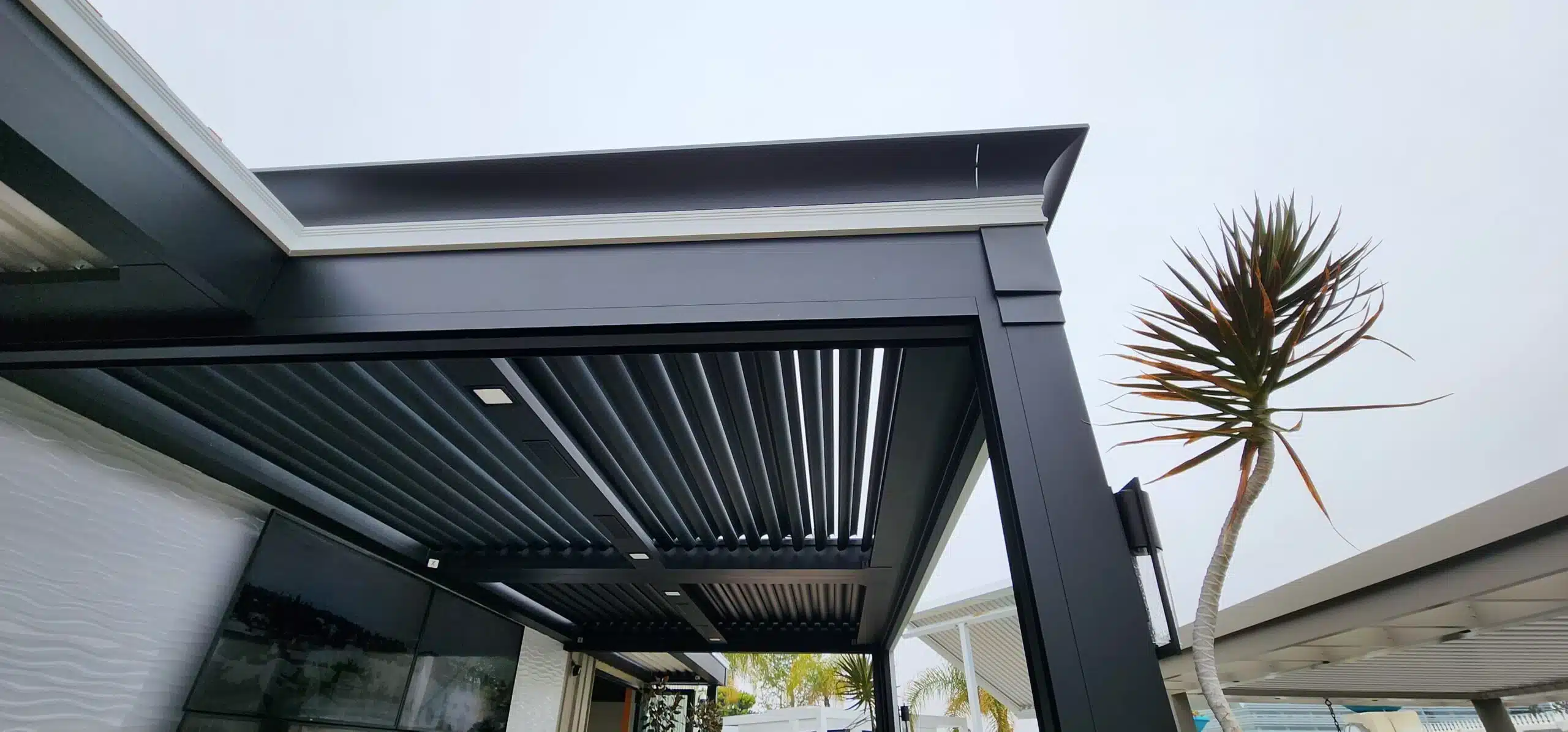 Side view of of a black Louvered Pergola