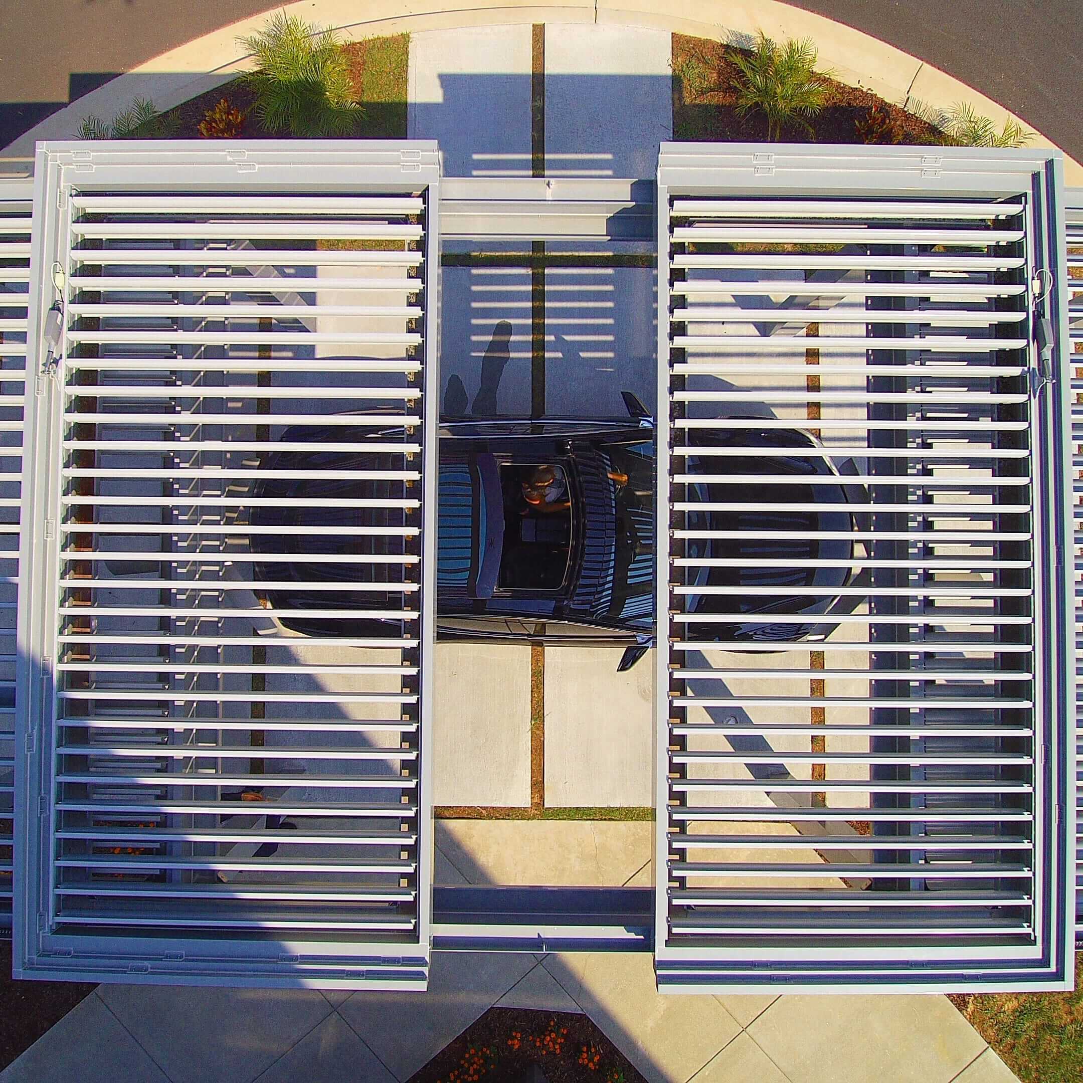 Louvered Garage Pergola with a black car parked