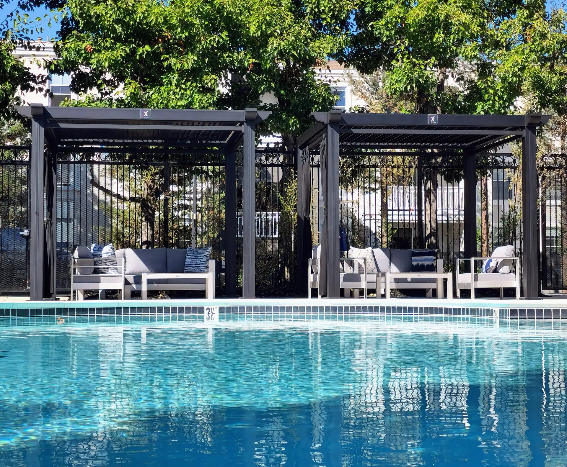 photo of StruXure Cabana X models providing for relaxing areas with shade next to a pool.