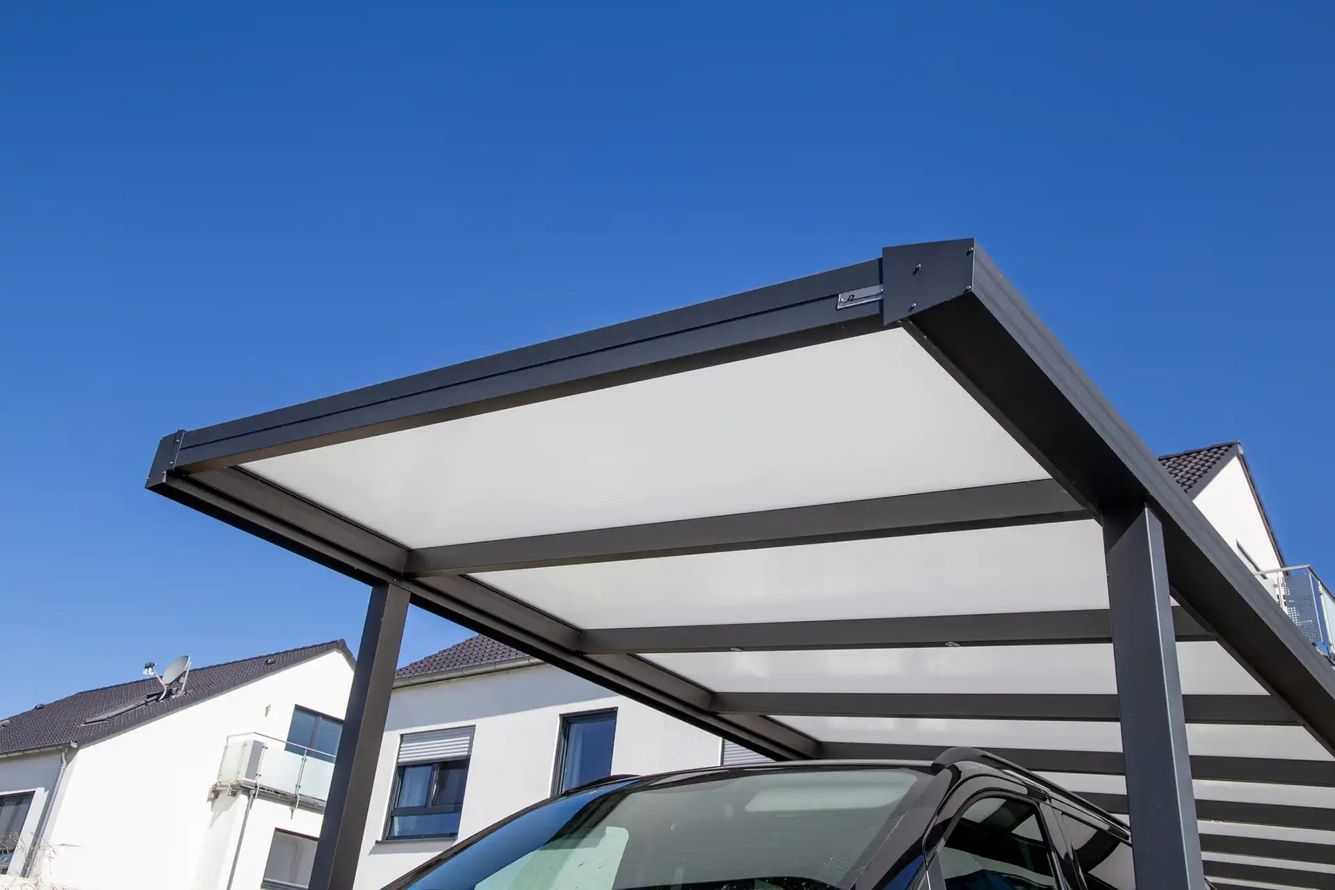 Photo of rectangular plexiglass garage pergola