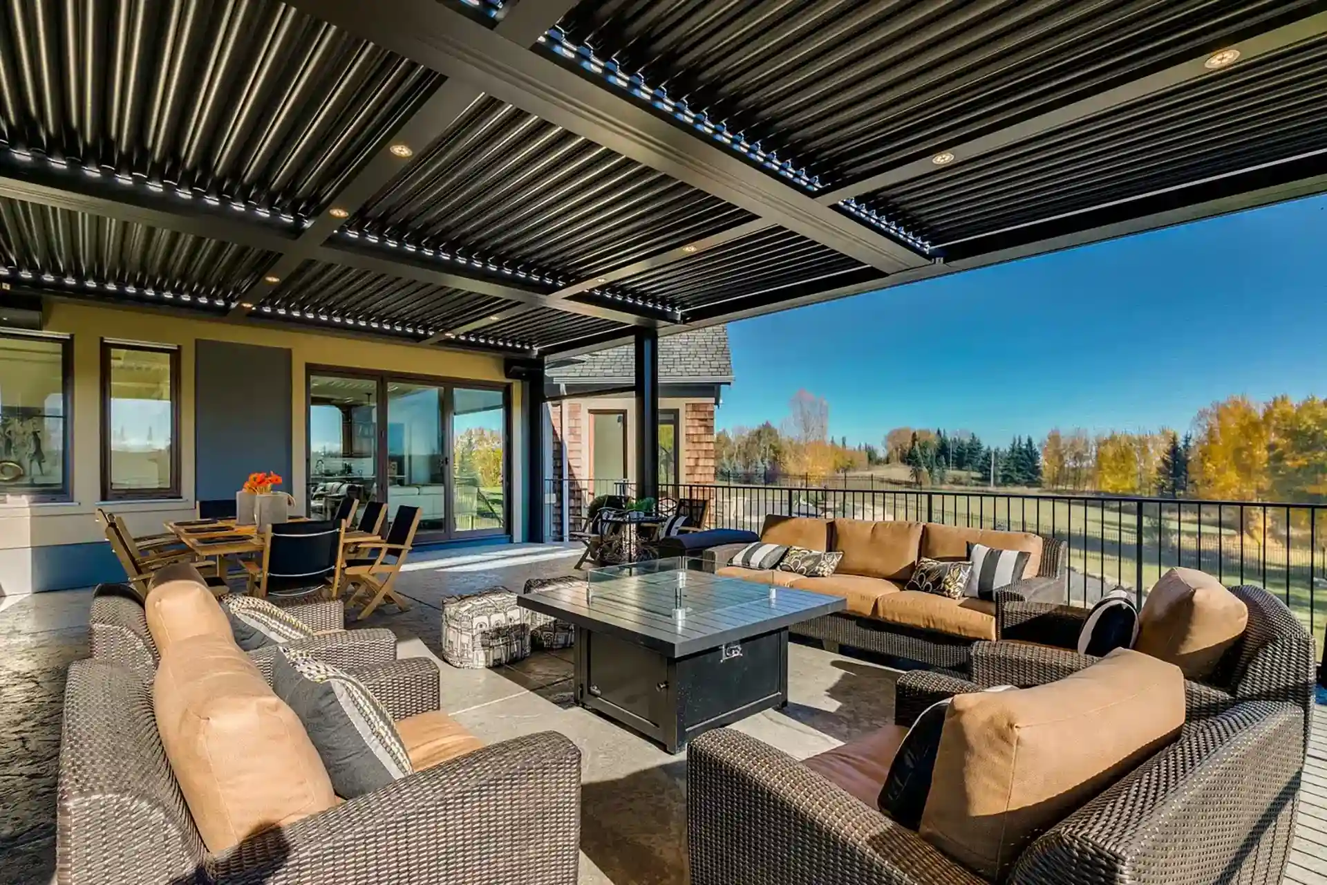 photo of an elaborate StruXure pergola with outdoor furniture and fire pit.