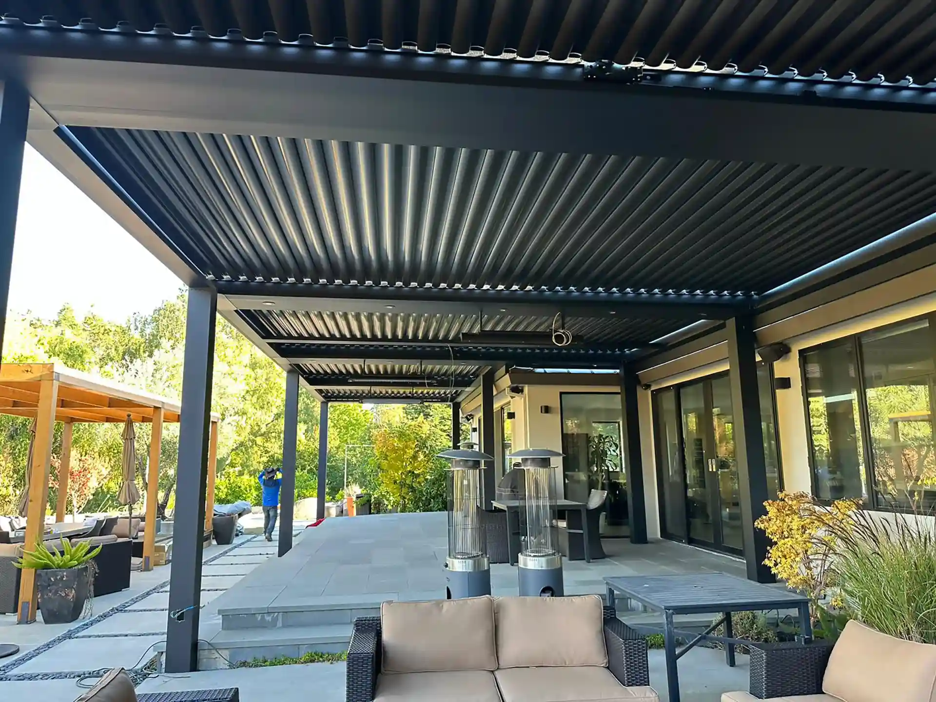 photo of a StruXure pergola along with a wooden pergola structure
