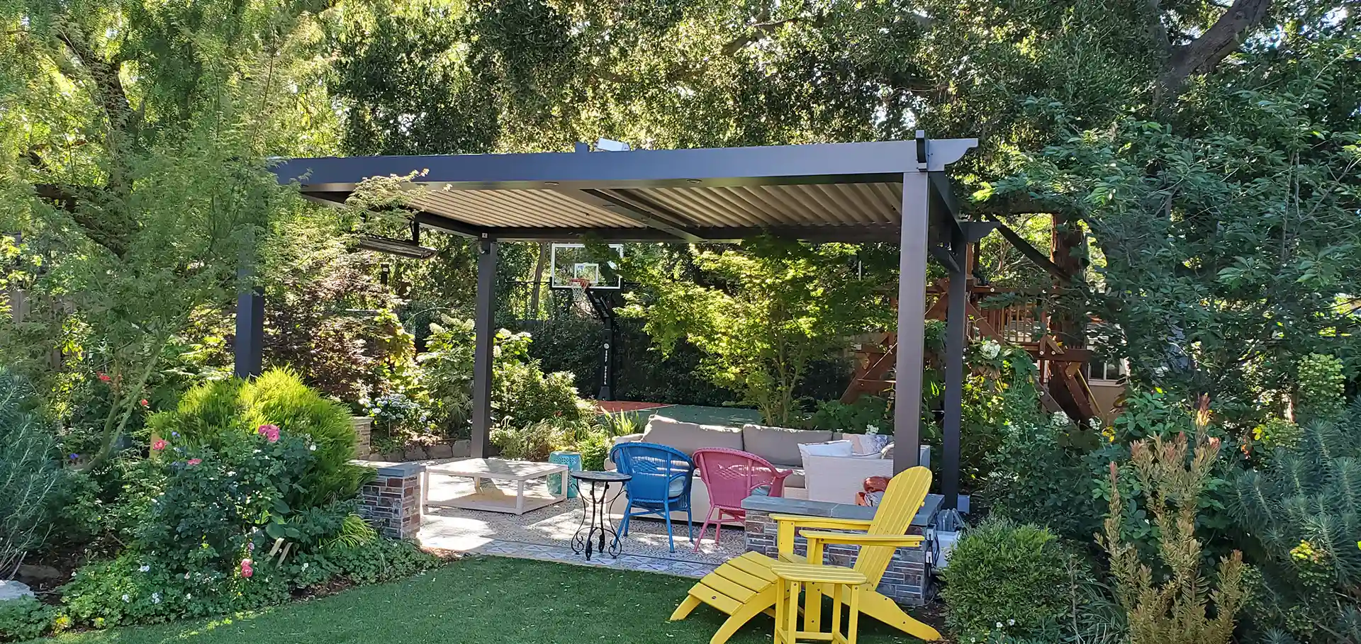 Photo of a StruXure with greenery surrounding it as a way to see how to decorate a pergola
