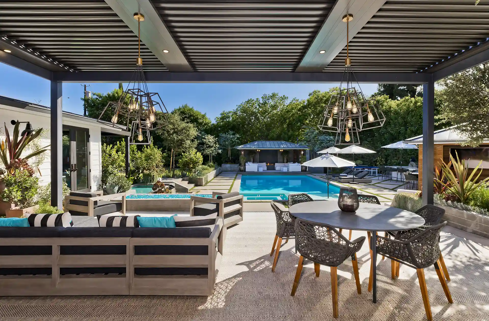 Photo of a luxury pergola that is poolsikde, featuring outdoor lighting and outdoor furniture
