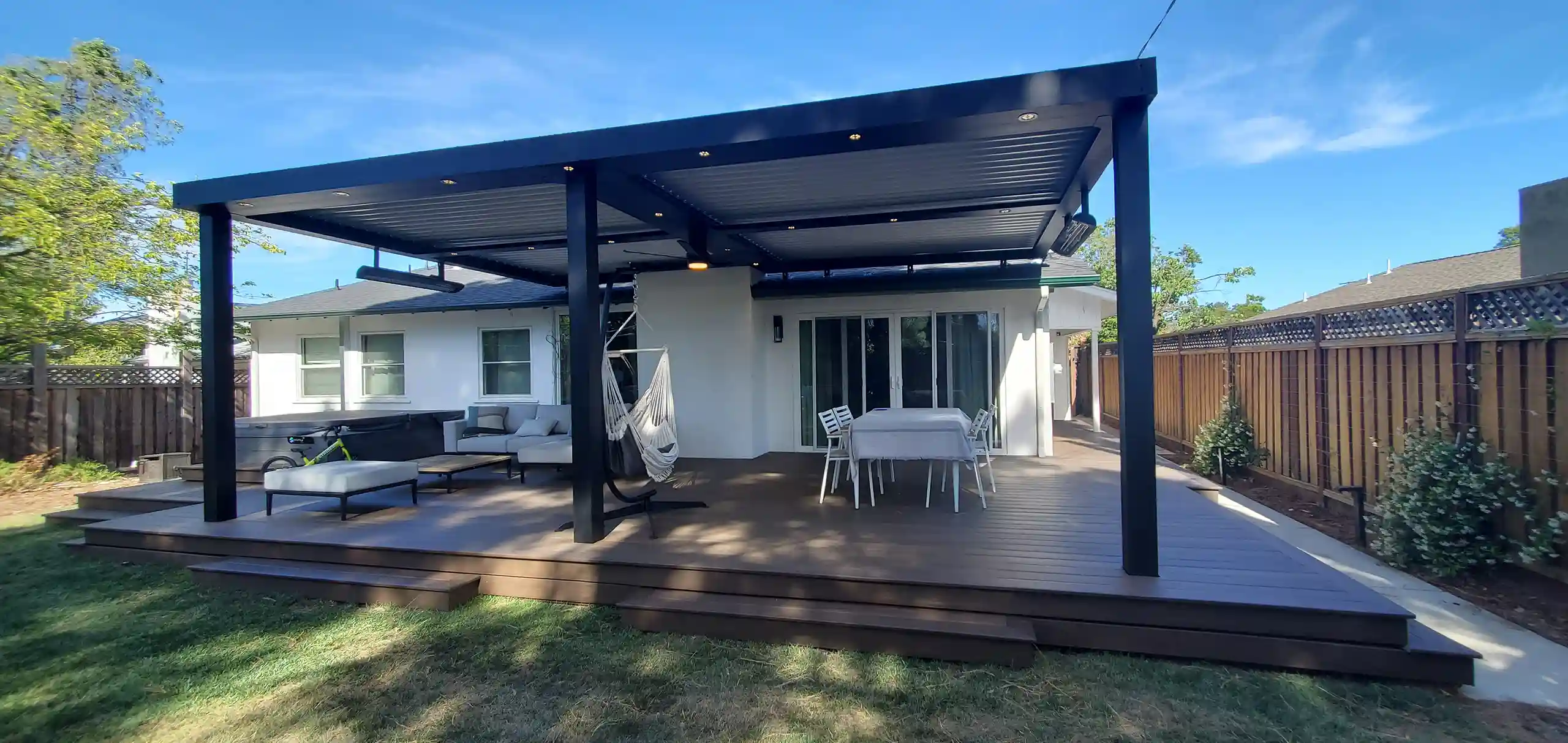 Photo of a StruXure pergola with heaters, ceiling fan, and lights.